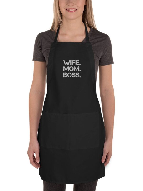 "Wife. Mom. Boss." displayed prominently on the chest area. This apron is designed for the modern woman who proudly plays multiple roles