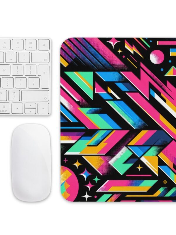 A hand resting on a ZestFiesta Mouse Pad, which displays a vivid geometric pattern in bright shades of pink, blue, yellow, and black, providing a colorful and dynamic surface for mouse usage.